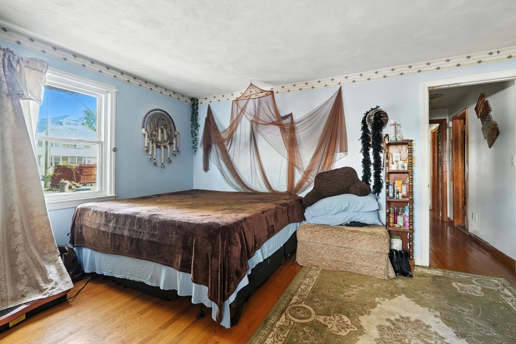 222-224 Main Street Springfield, MA 01151 - Photo 15 of 42 a bedroom with a bed and a window