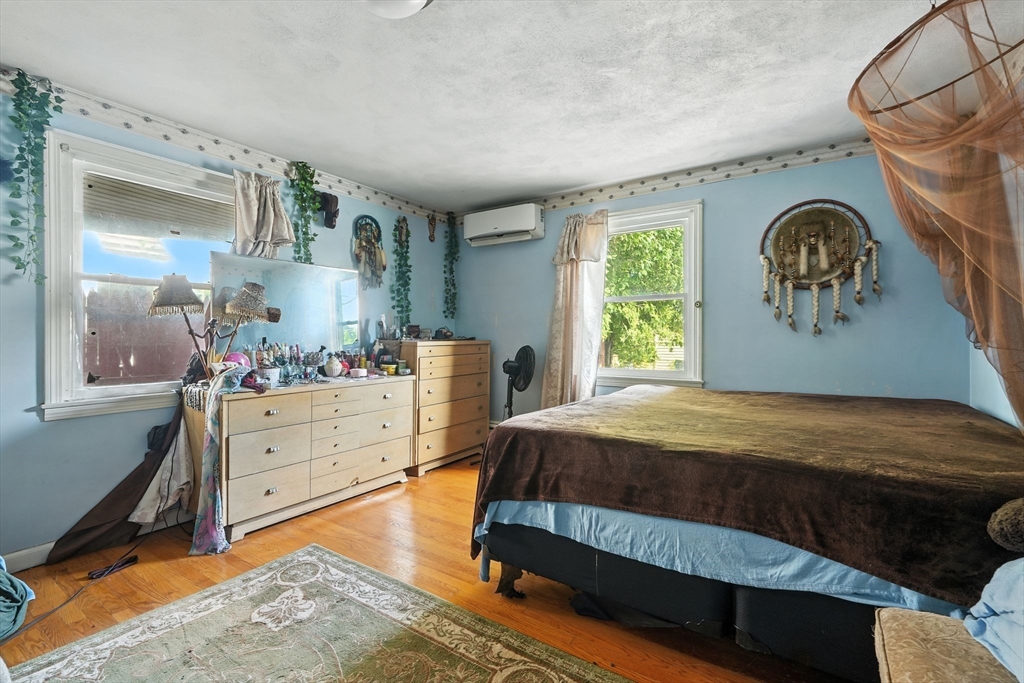 222-224 Main Street Springfield, MA 01151 - Photo 16 of 42 a bedroom with a bed and a table in it