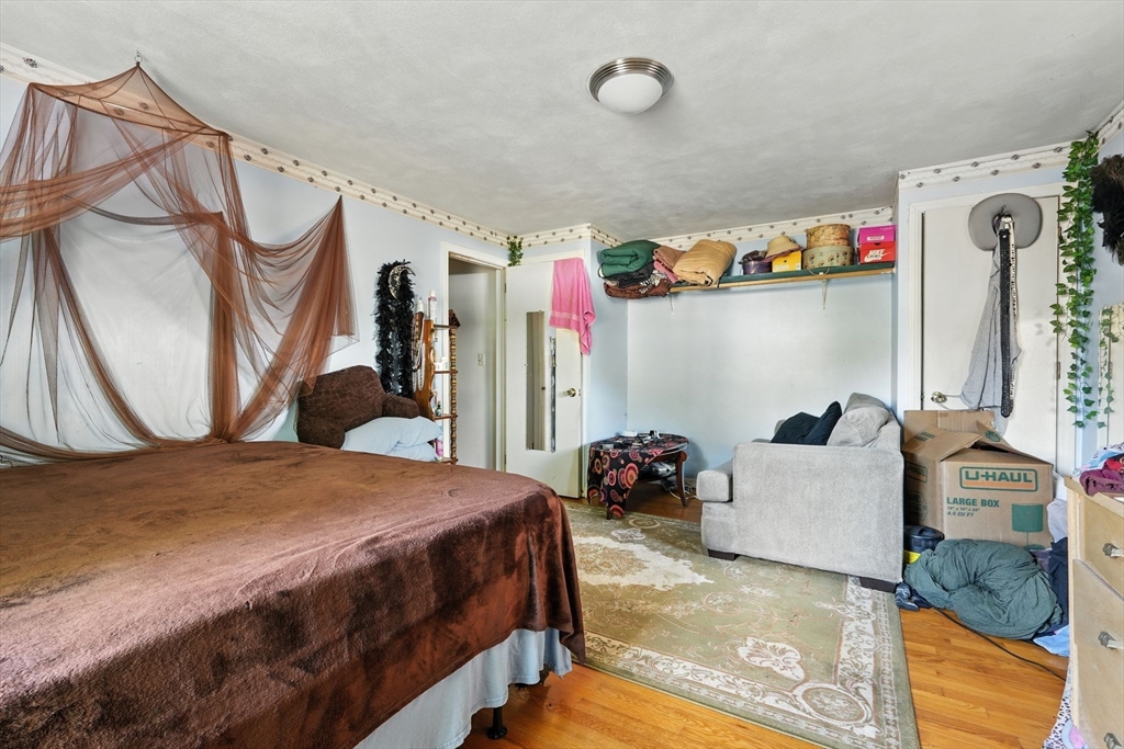 222-224 Main Street Springfield, MA 01151 - Photo 17 of 42 a bedroom with a bed and cabinets