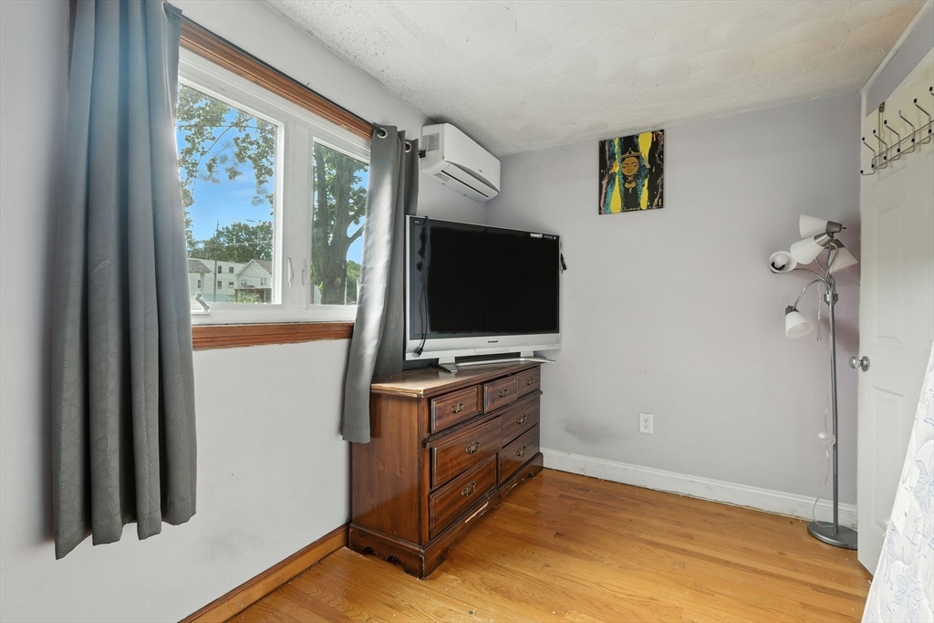222-224 Main Street Springfield, MA 01151 - Photo 19 of 42 a living room with furniture and a flat screen tv