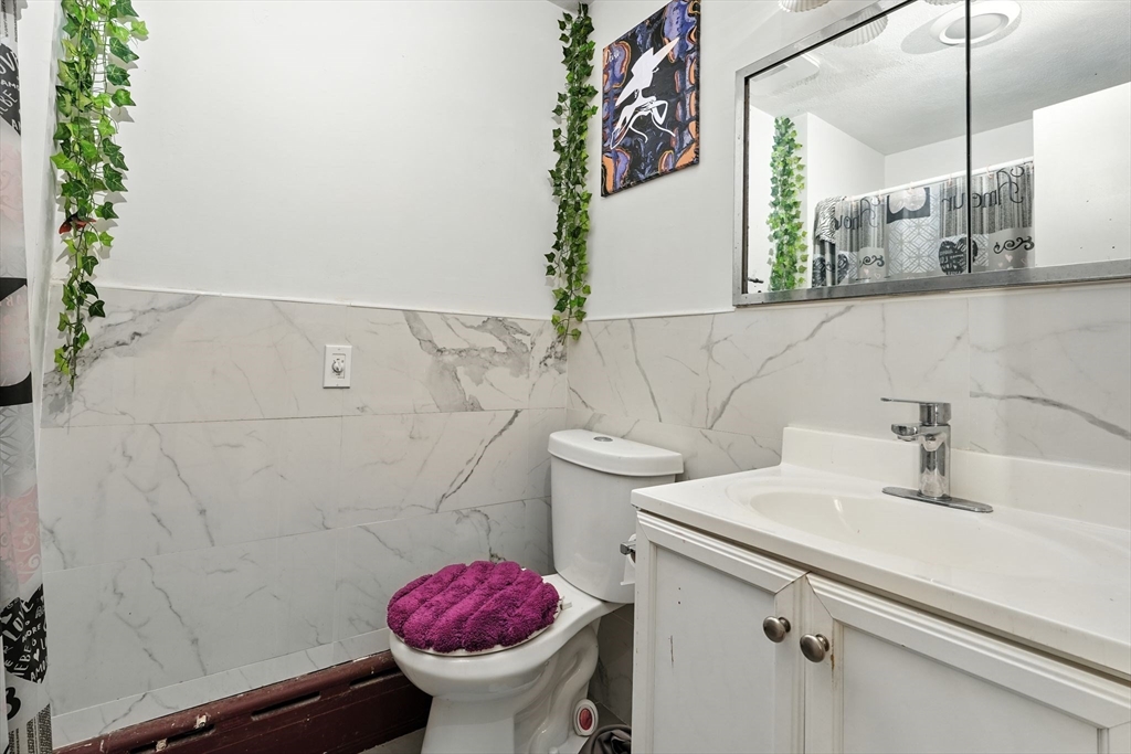 222-224 Main Street Springfield, MA 01151 - Photo 21 of 42 a bathroom with a sink and mirror with toilet