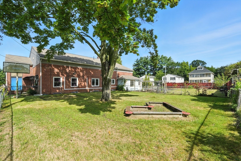 222-224 Main Street Springfield, MA 01151 - Photo 24 of 42 a front view of a house with a yard table and chairs