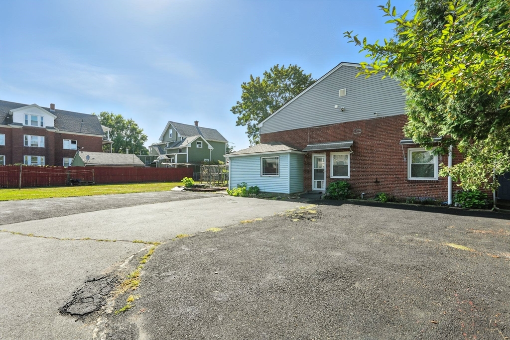 222-224 Main Street Springfield, MA 01151 - Photo 25 of 42 a view of a house with a yard and a large tree