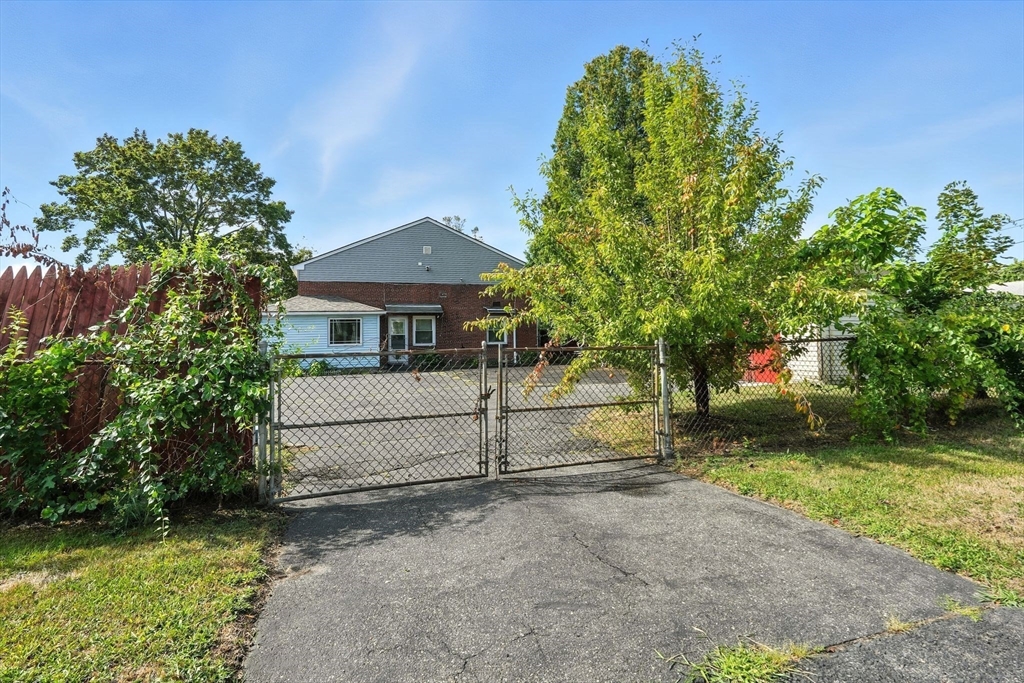 222-224 Main Street Springfield, MA 01151 - Photo 30 of 42 a front view of a house with a yard and a garage