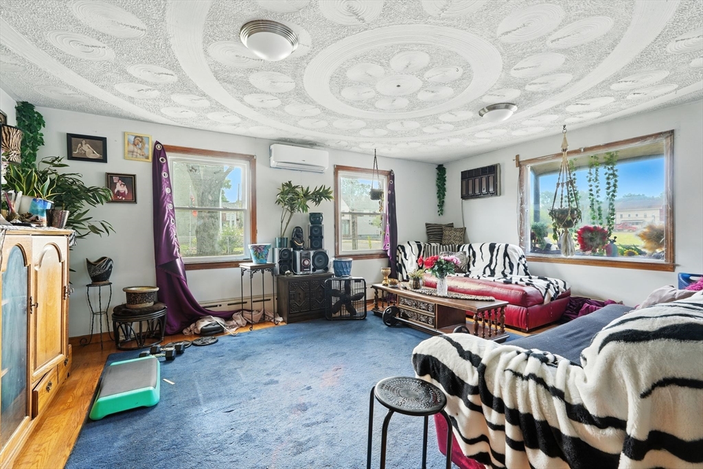 222-224 Main Street Springfield, MA 01151 - Photo 10 of 42 a bed room with furniture and a chandelier