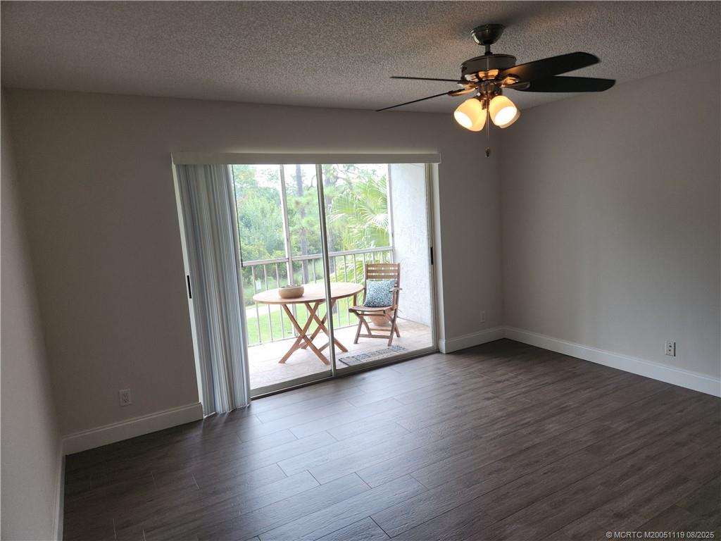 2502 Southeast Anchorage Cove, Unit H2 Port St. Lucie, FL 34952 - Photo 10 of 37 an empty room with wooden floor and windows