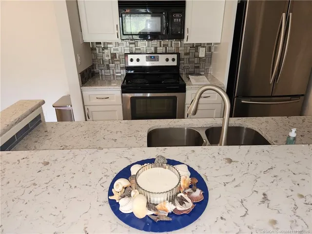 a kitchen with a stove a sink and a microwave