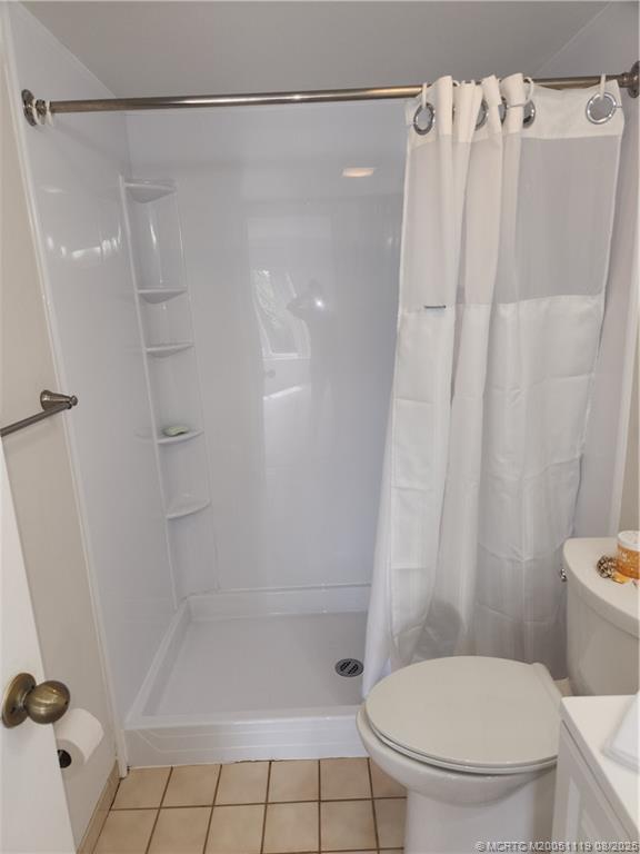 2502 Southeast Anchorage Cove, Unit H2 Port St. Lucie, FL 34952 - Photo 18 of 37 a bathroom with a shower and a toilet