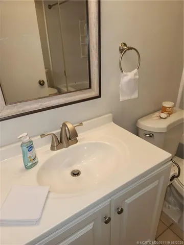 a bathroom with a toilet sink and mirror