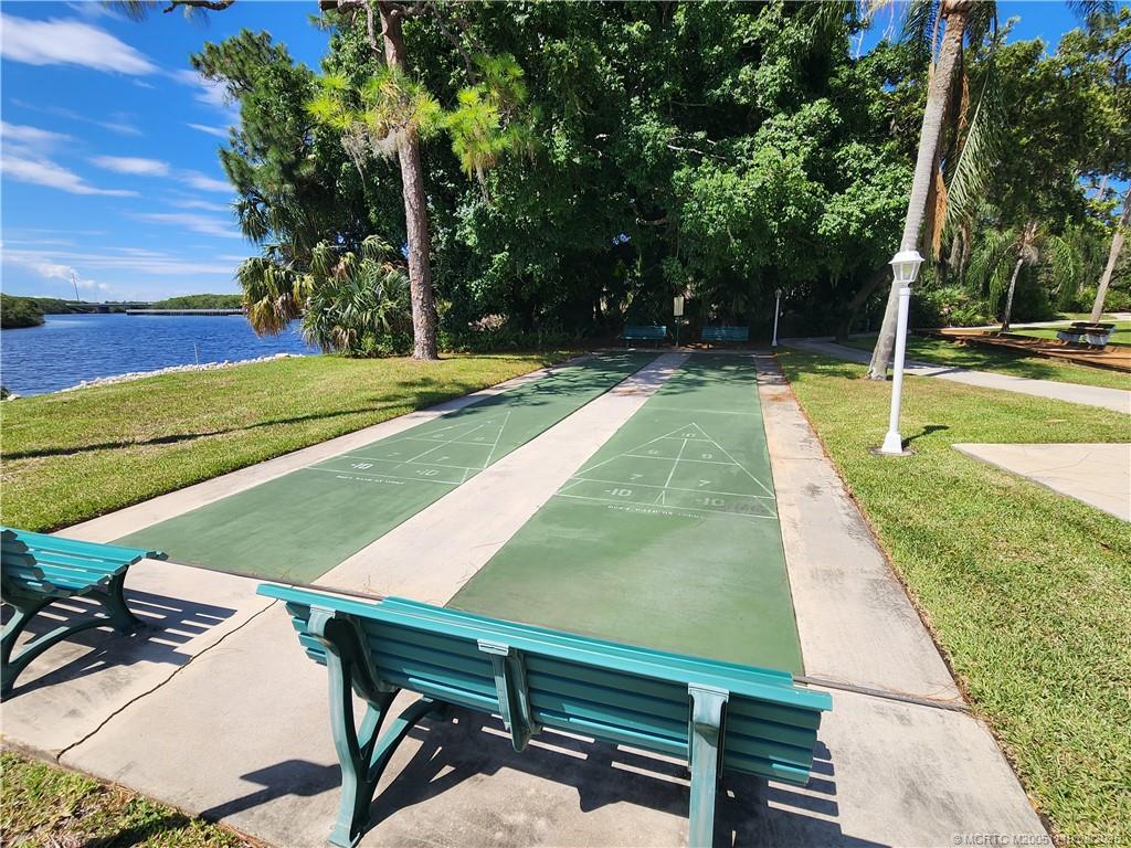 2502 Southeast Anchorage Cove, Unit H2 Port St. Lucie, FL 34952 - Photo 32 of 37 a view of a backyard with swimming pool