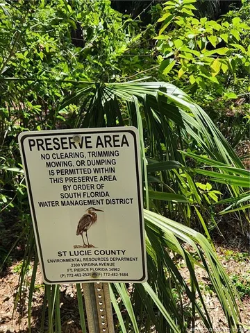 a view of a garden with a bench and a lake view
