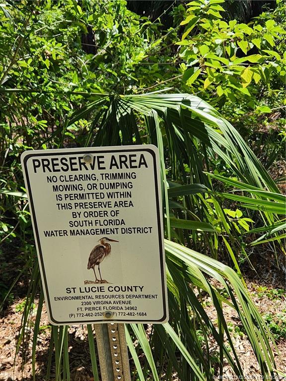 2502 Southeast Anchorage Cove, Unit H2 Port St. Lucie, FL 34952 - Photo 35 of 37 a sign on the side of the tree