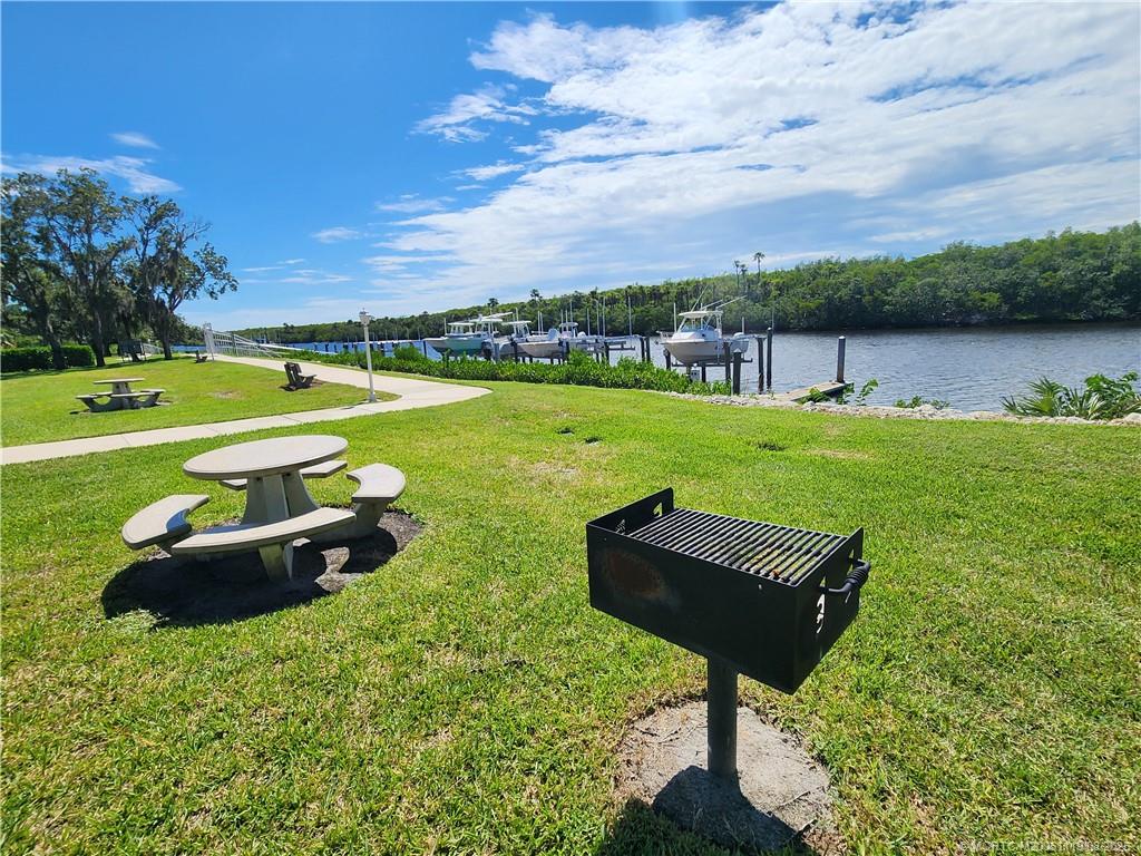 2502 Southeast Anchorage Cove, Unit H2 Port St. Lucie, FL 34952 - Photo 4 of 37 a view of a garden with lawn chairs