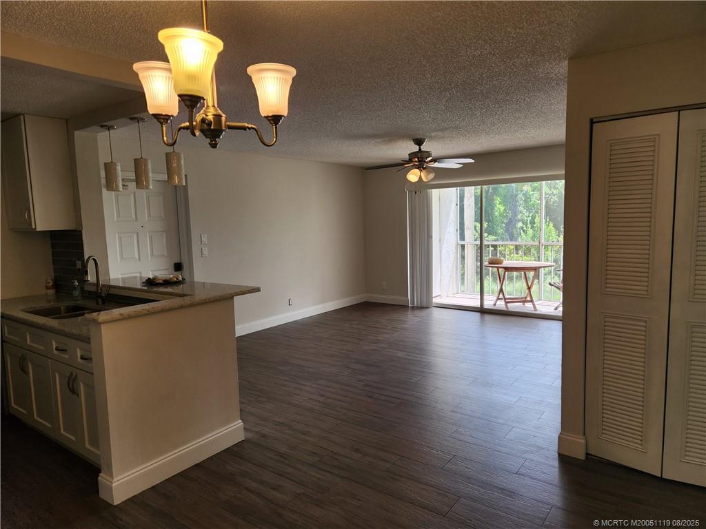 2502 Southeast Anchorage Cove, Unit H2 Port St. Lucie, FL 34952 - Photo 37 of 37 a kitchen with stainless steel appliances granite countertop a stove and a wooden floor