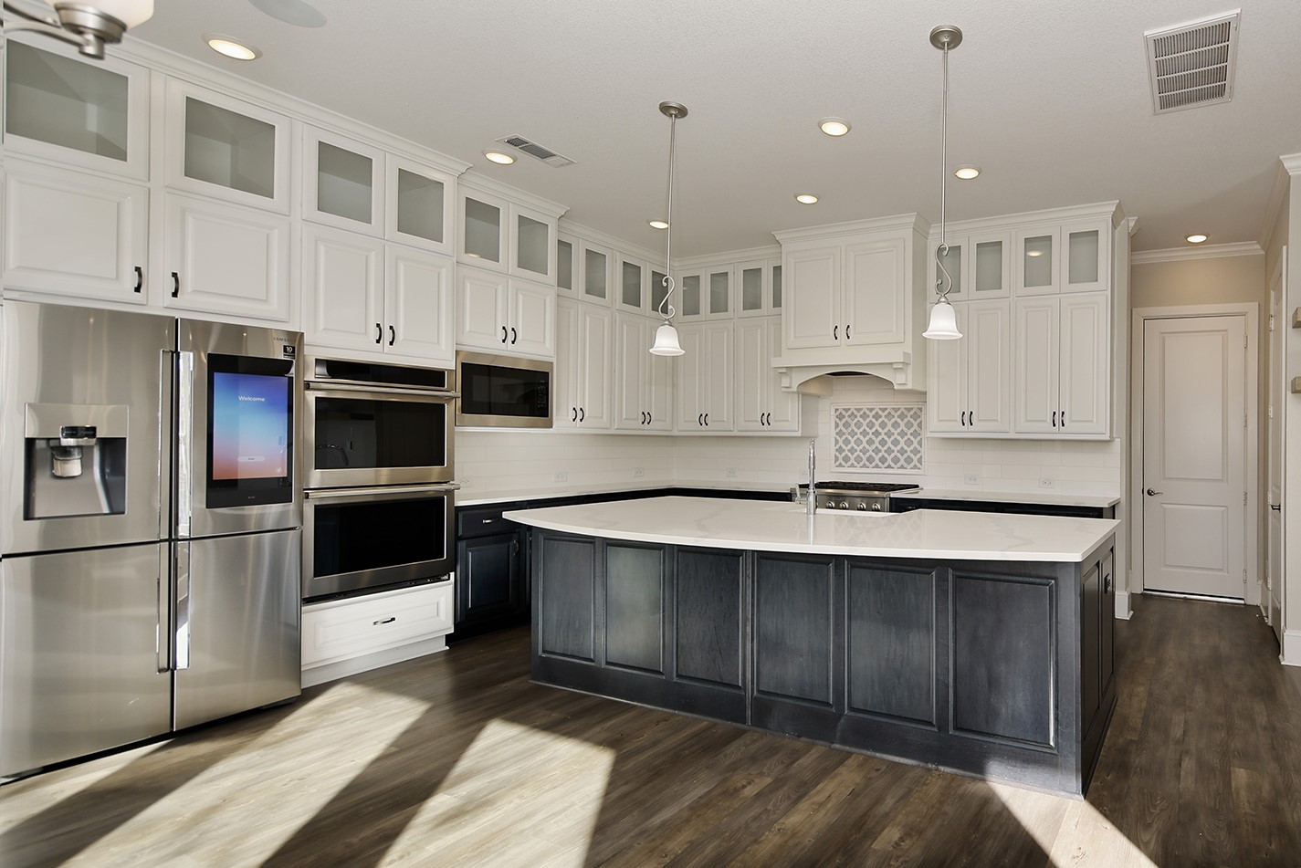 543 Kingston Lane Conroe, TX 77384 - Photo 12 of 33 a kitchen with stainless steel appliances kitchen island a refrigerator sink and cabinets