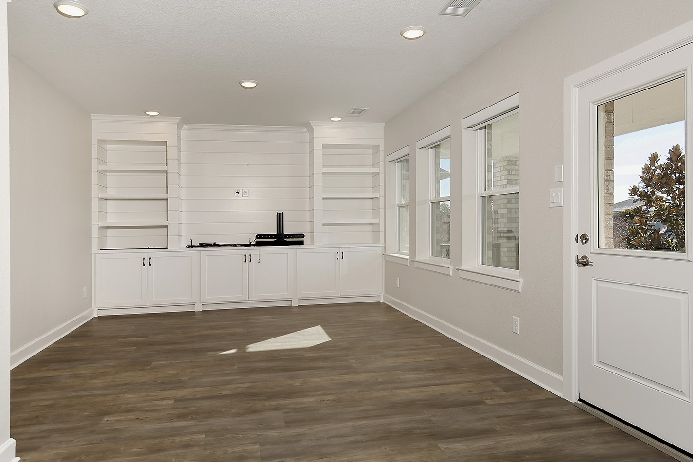 543 Kingston Lane Conroe, TX 77384 - Photo 16 of 33 a view of empty room with wooden floor and windows