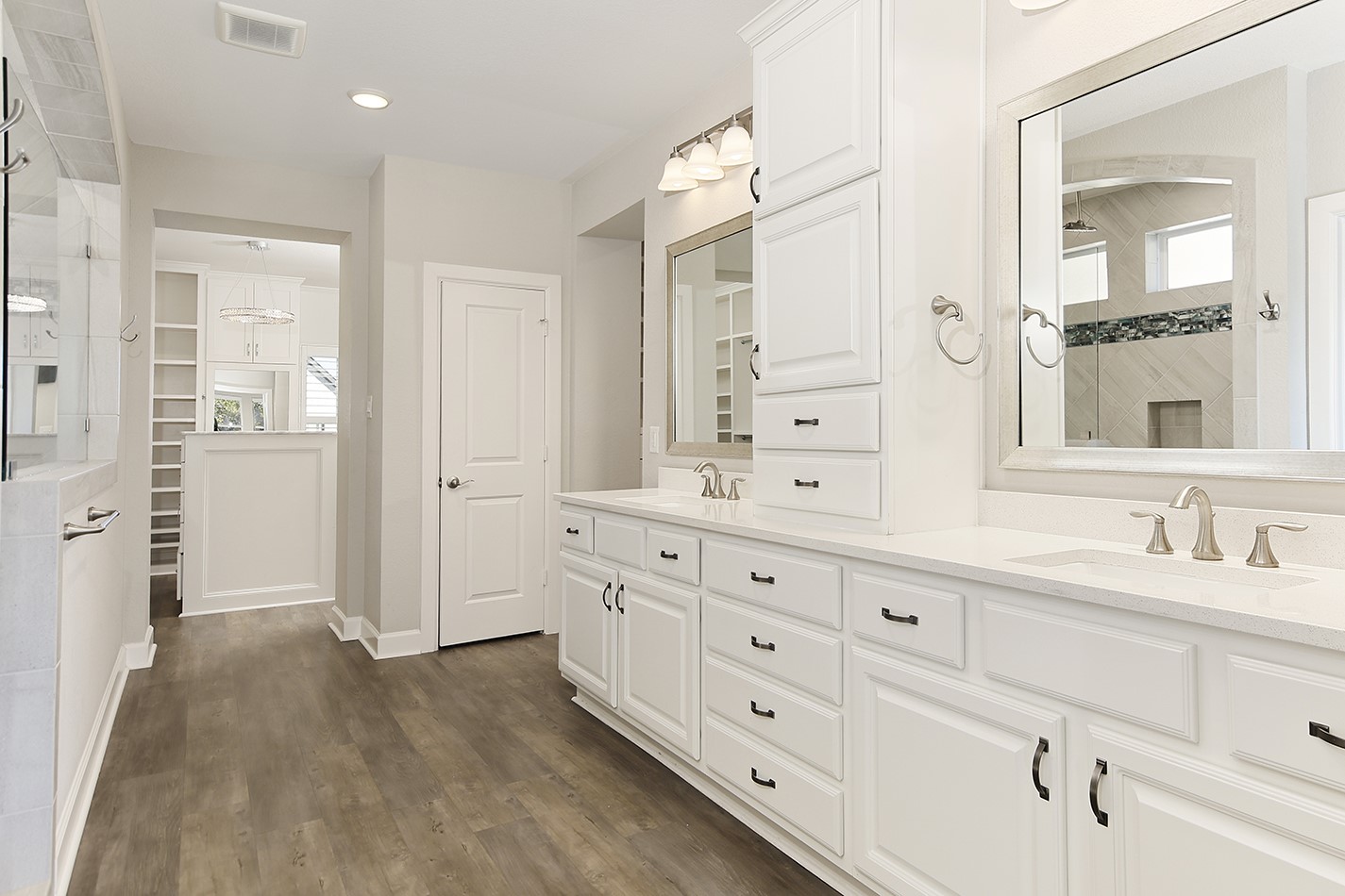 543 Kingston Lane Conroe, TX 77384 - Photo 19 of 33 a spacious bathroom with double vanity sink a mirror and a shower