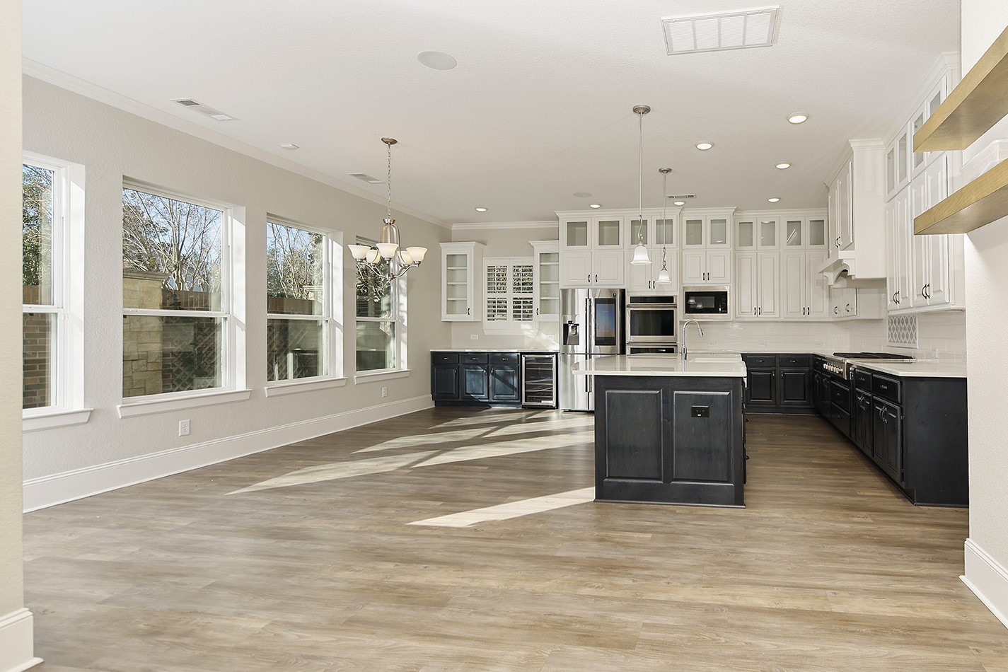 543 Kingston Lane Conroe, TX 77384 - Photo 10 of 33 a view of kitchen with stainless steel appliances granite countertop a stove top oven a sink dishwasher a dining table and chairs with wooden floor