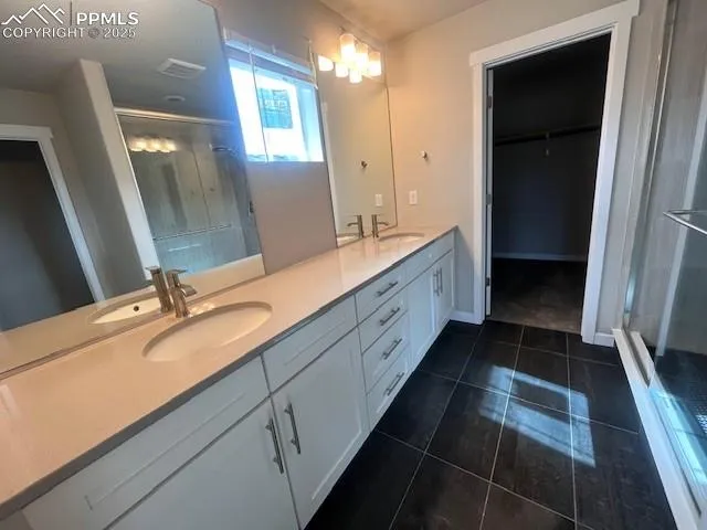 a bathroom with a double vanity sink and a mirror