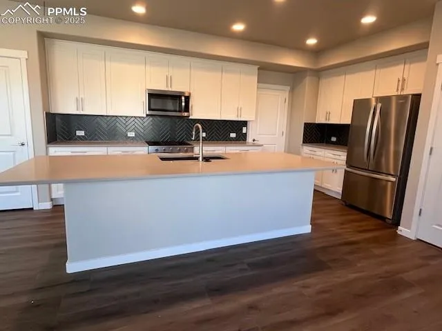 a kitchen with stainless steel appliances granite countertop a granite counter tops and a stove