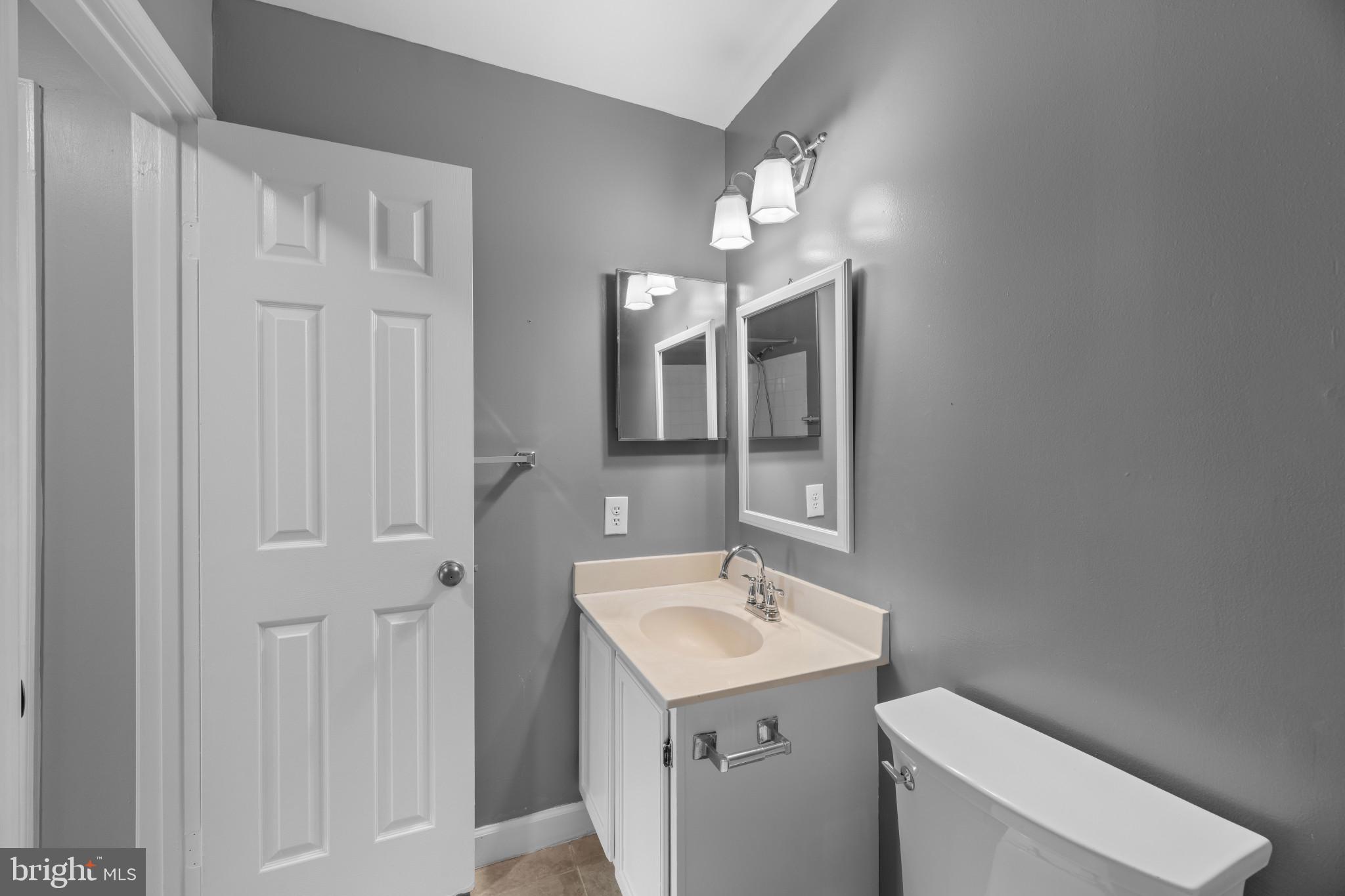 9302 Player Drive, Unit 155 Laurel, MD 20708 - Photo 37 of 43 a bathroom with a toilet sink and mirror