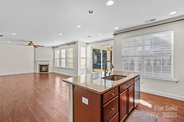 a kitchen that has a sink and a wooden floor