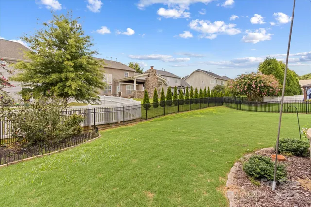a view of a house with a big yard and potted plants