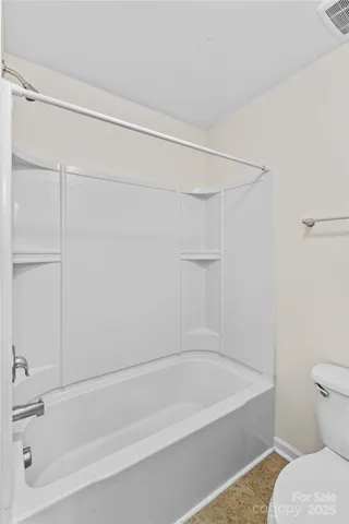 a bathroom with a bathtub and a toilet
