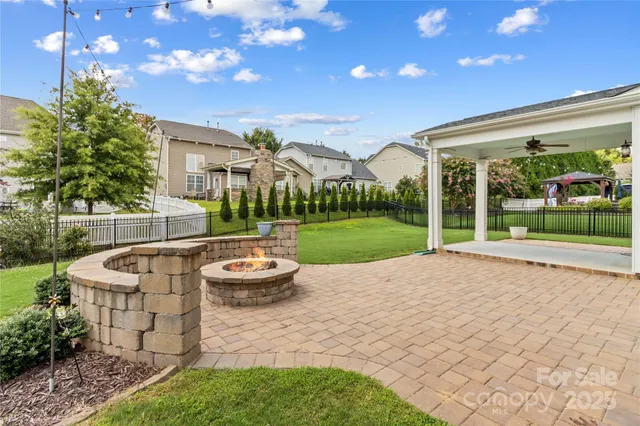 a view of a house with backyard and patio