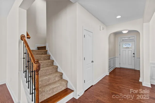 a view of a hallway with wooden floor and entryway