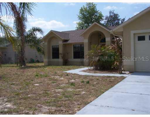 1600 Dublin Road Deltona, FL 32738 - Photo 1 of 1 a front view of a house with garden