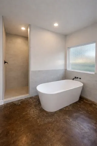 a bathroom with a bathtub and window