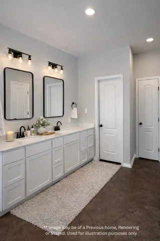 a spacious bathroom with a double vanity sink and mirror