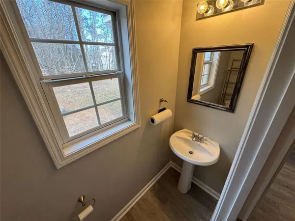 a bathroom with a sink a toilet and a window
