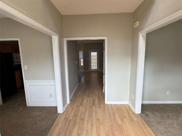 wooden floor in a bedroom next to a window