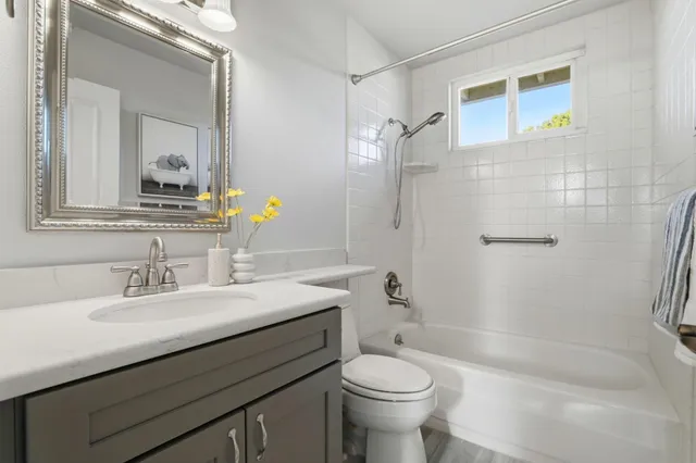 a bedroom with a bed and a wall painting