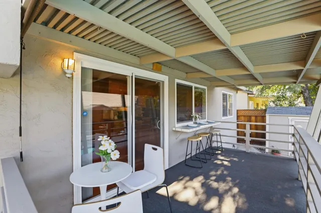 a view of a house with pool and chairs