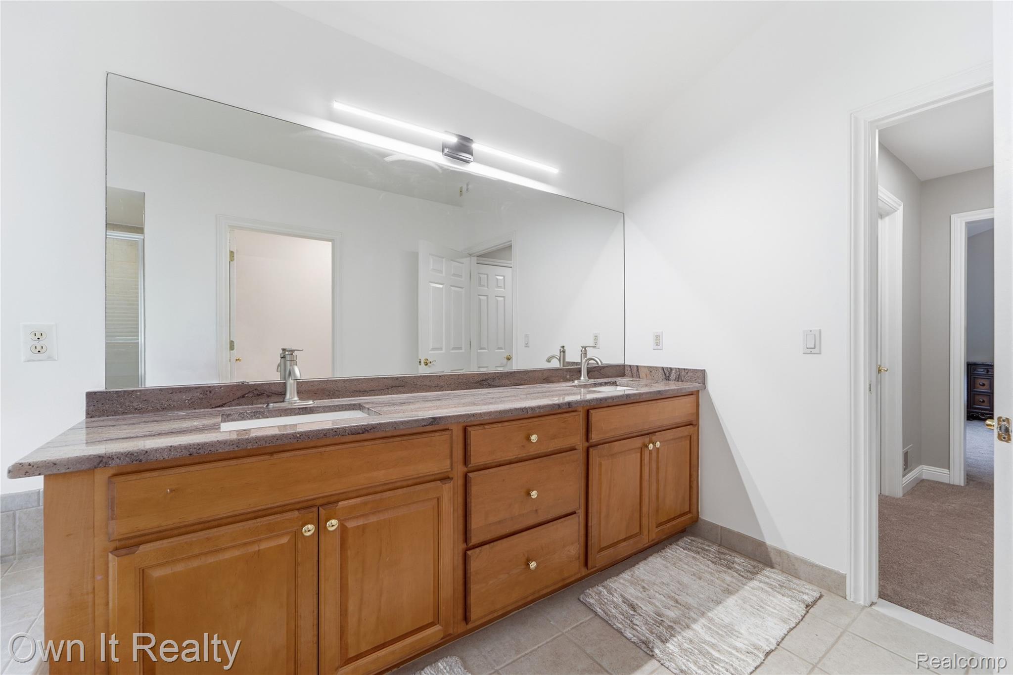 48280 Gladstone Road Canton, MI 48188 - Photo 36 of 59 Double vanity with a brown-toned countertop and dual under-mount sinks