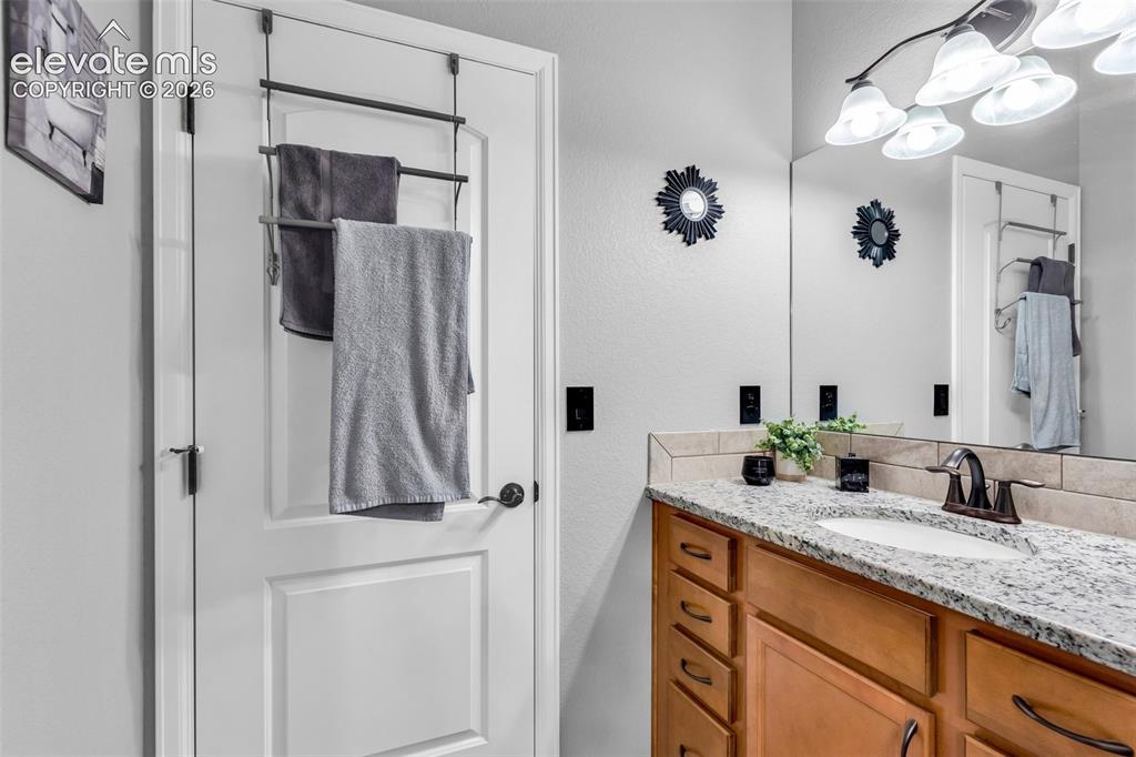 415 Empire Road Canon City, CO 81212 - Photo 22 of 40 a bathroom with a sink vanity and a mirror