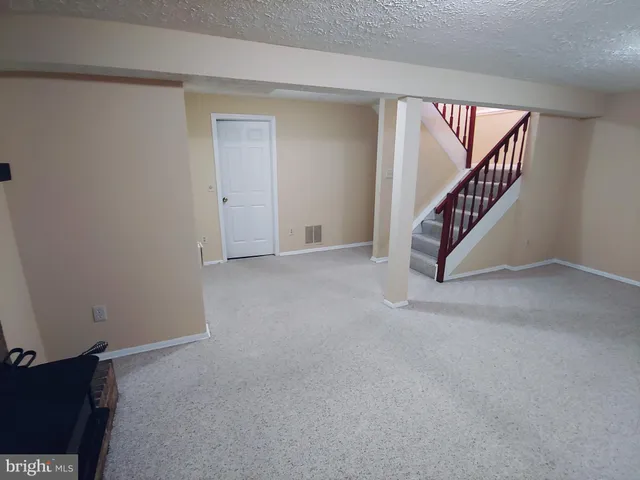 a view of an empty room with stairs