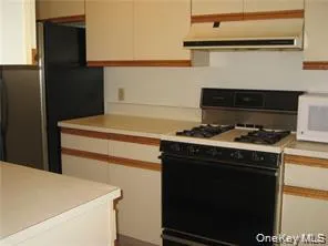 a stove top oven sitting inside of a kitchen