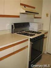 a stove top oven sitting inside of a kitchen