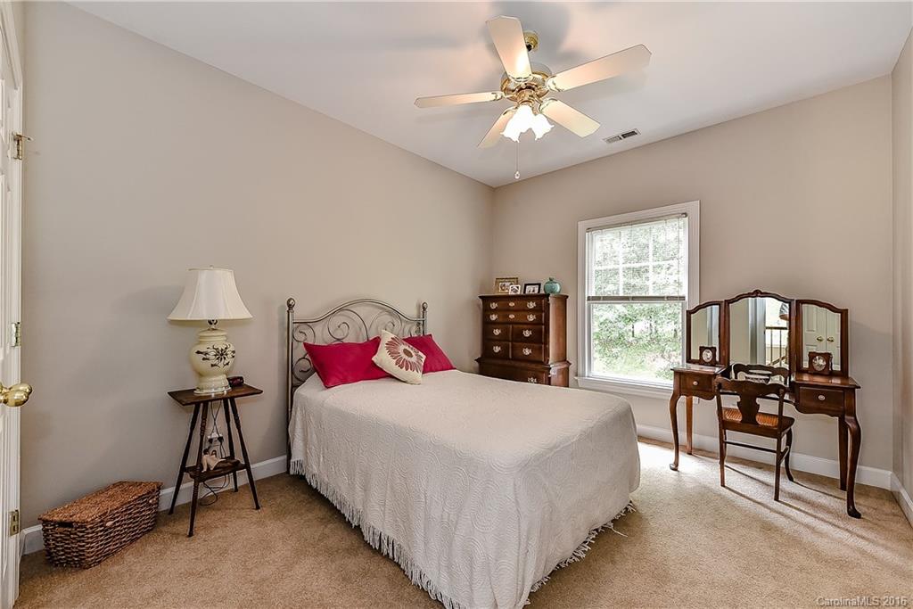 325 Kimberly Road Davidson, NC 28036 - Photo 18 of 22 a bedroom with a bed a table and chair