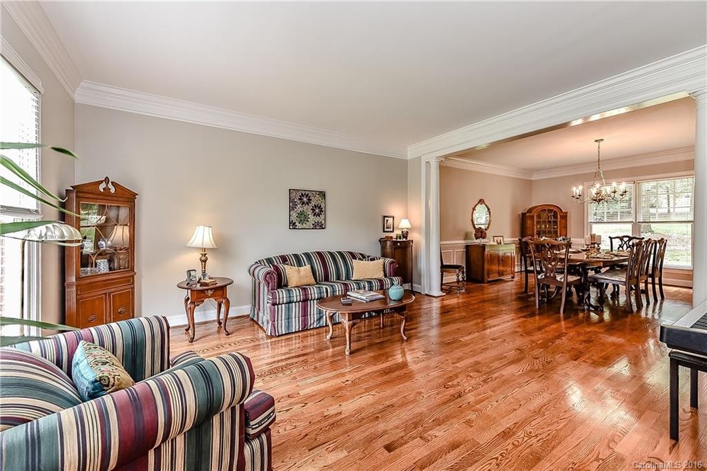 325 Kimberly Road Davidson, NC 28036 - Photo 3 of 22 a living room with furniture and a dining table