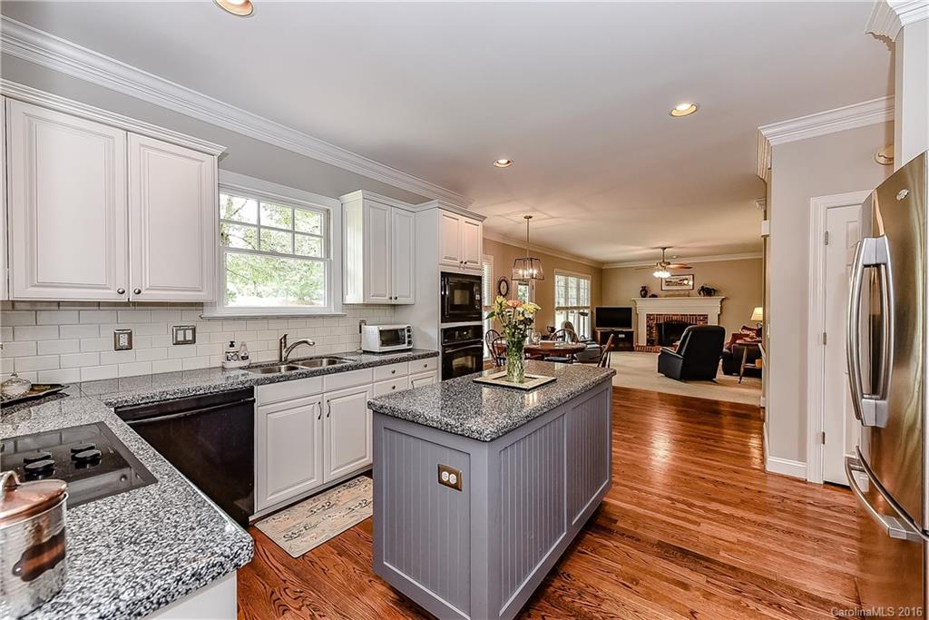 325 Kimberly Road Davidson, NC 28036 - Photo 7 of 22 a kitchen with stainless steel appliances granite countertop a stove a sink dishwasher and a refrigerator