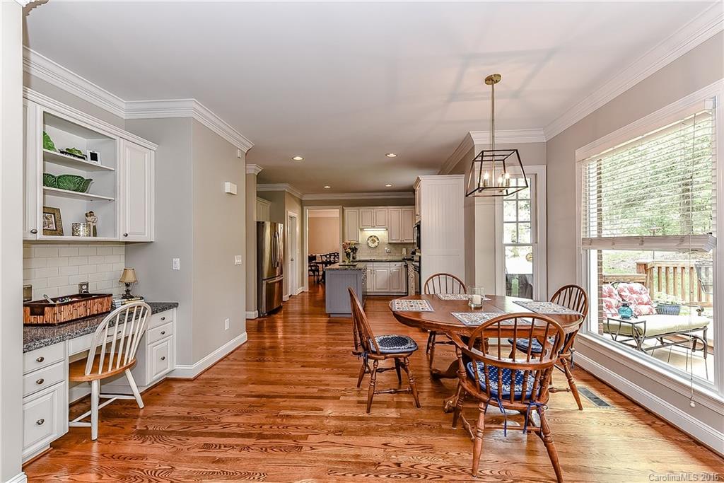 325 Kimberly Road Davidson, NC 28036 - Photo 10 of 22 a dining room with furniture a chandelier and wooden floor