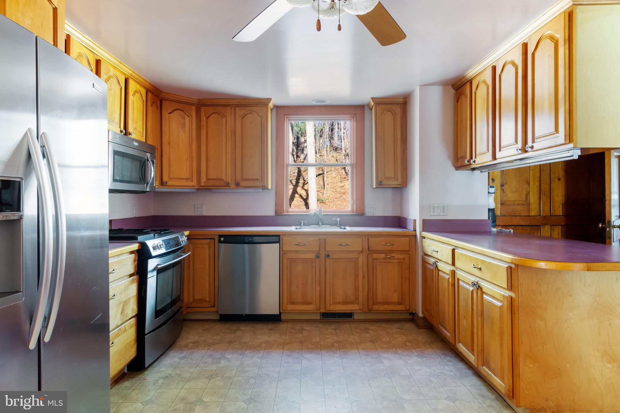 4100 Simpson Drive Westminster, MD 21158 - Photo 13 of 52 a kitchen with stainless steel appliances granite countertop a refrigerator a stove and a sink