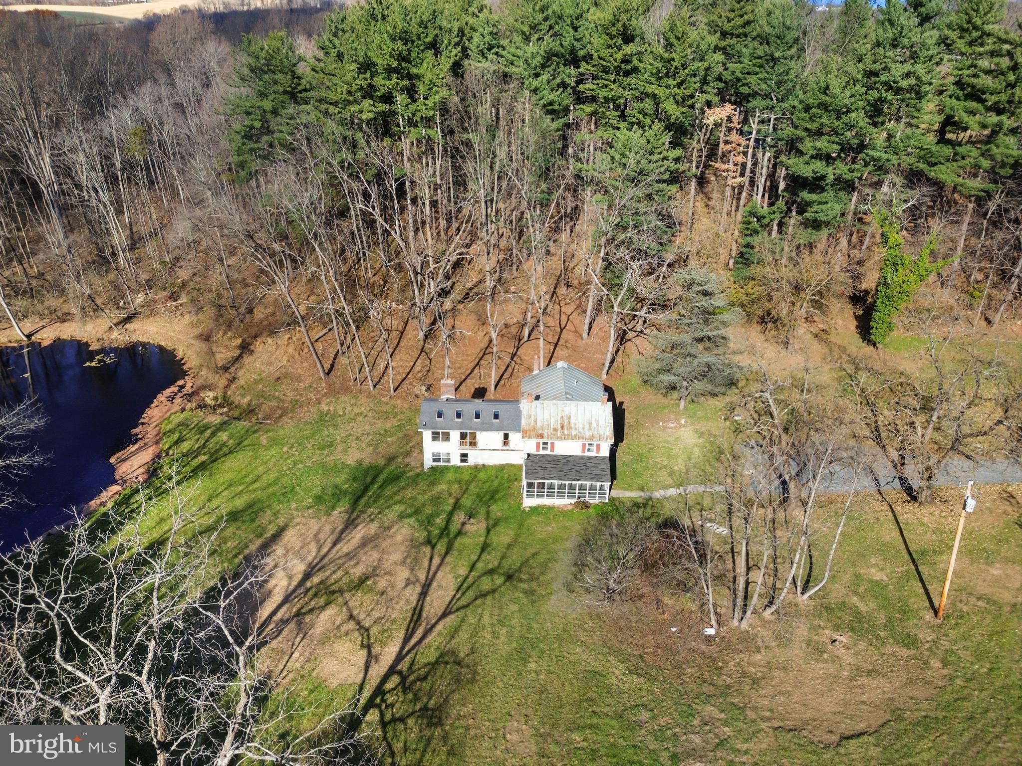 4100 Simpson Drive Westminster, MD 21158 - Photo 45 of 52 a view of a yard with plants and a bench