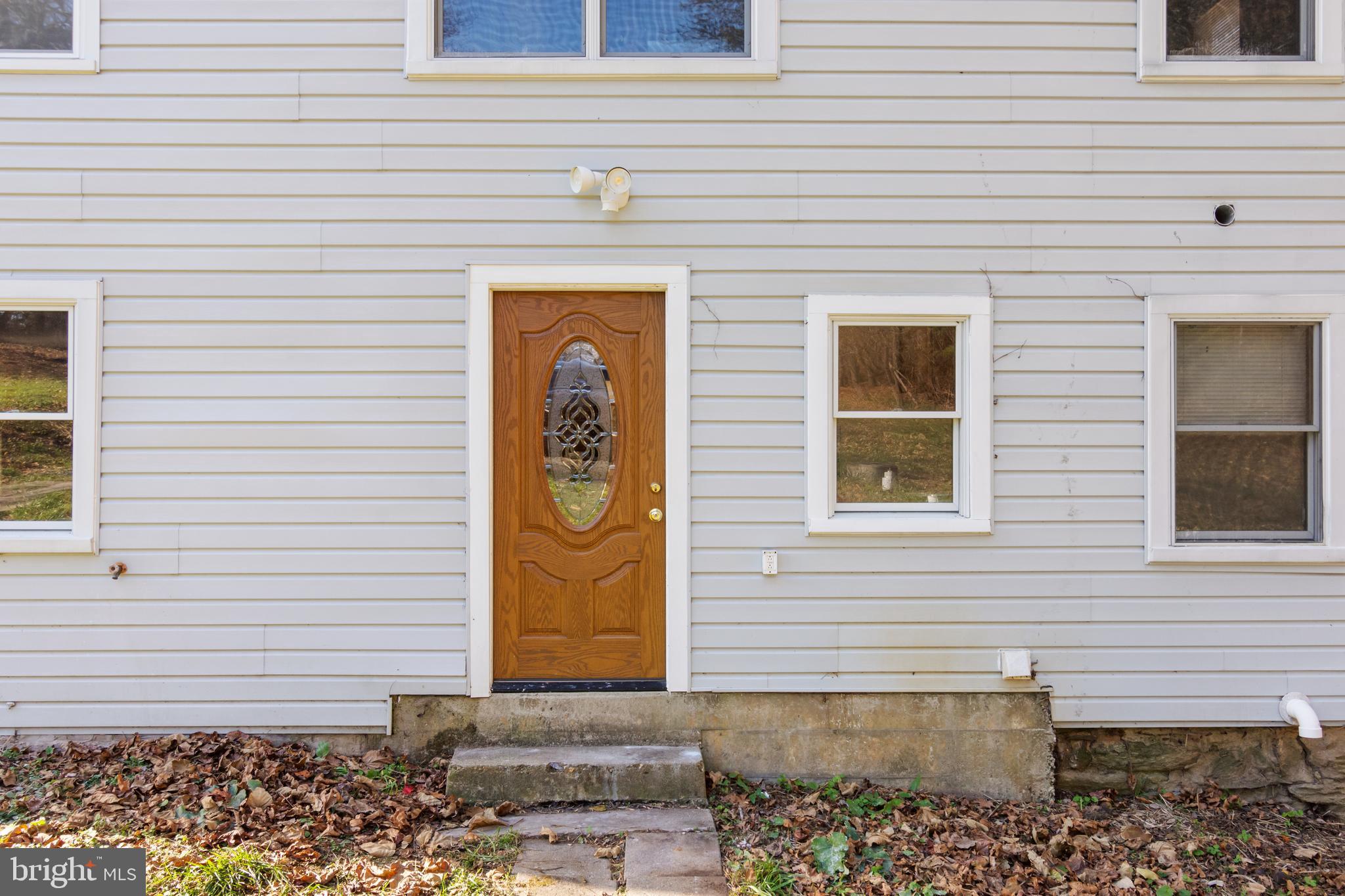 4100 Simpson Drive Westminster, MD 21158 - Photo 5 of 52 a front view of a house with a garage