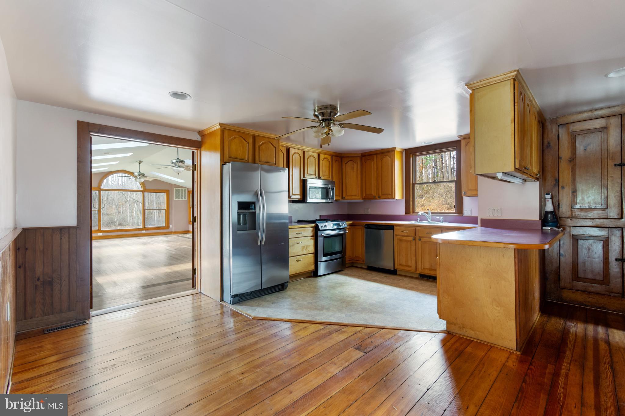 4100 Simpson Drive Westminster, MD 21158 - Photo 10 of 52 a kitchen with stainless steel appliances wooden floor and large cabinets